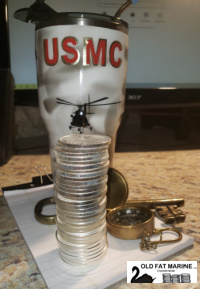 a epoxy colored mug that was decorated by wife.  The mug has a helicopter which looks like it is carrying 33 ounces of silver .  There is also a compass and an oversized old fashioned key to symbolize what they symbolize.