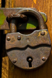 A close-up photo of a very old padlock.  