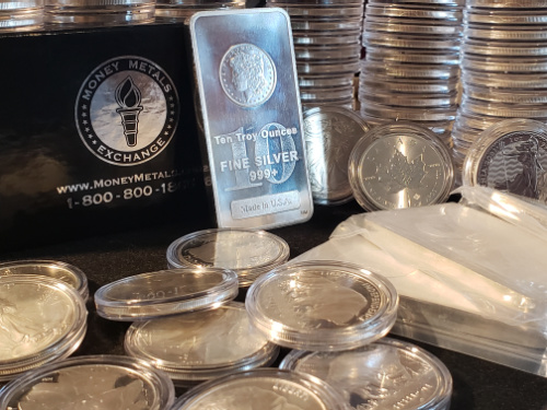 A small pile of silver rounds and a 10 ounce silver bar.  In a disorganized pile.