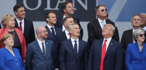 World leaders looking up into the sky while President Trump is the only one looking in the opposite direction.