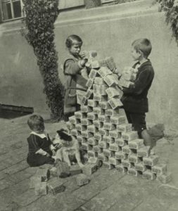 A photo from 1930's Weimar Republic showing young children playing with a pile of German worthless currency.  The photo is in black and white and the pile of cash is almost at tall as the 7 years old children.   Another example of the media lies about silver