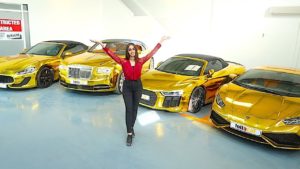 a photo of a lady in Dubai standing in front of four VERY expensive sport cars made out of gold.  Using the math formula to calculate the future silver price of 15 to 1 the value of these cars is tremendous.
